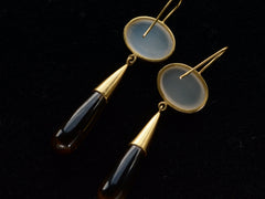 thumbnail of Reverse sides of 18K yellow gold earrings with oval moonstone tops and amber-colored quartz teardrop pendants, shown on dark background.