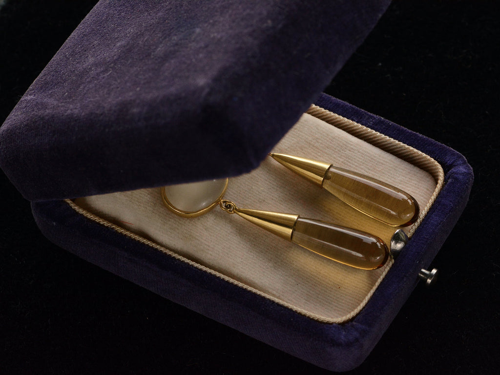 Pair of 18K yellow gold earrings with oval moonstone tops and amber-colored quartz teardrop pendants, shown in vintage partially closed.