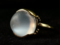 thumbnail of Right side view of vintage gold ring with silvery blue moonstone orb, shown on dark background.
