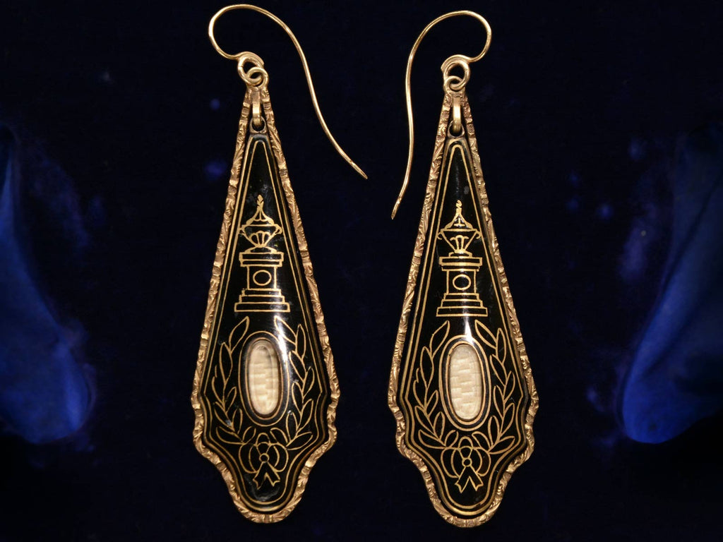 Front view of c1820 Georgian Black Enamel Earrings (shown on dark blue background)