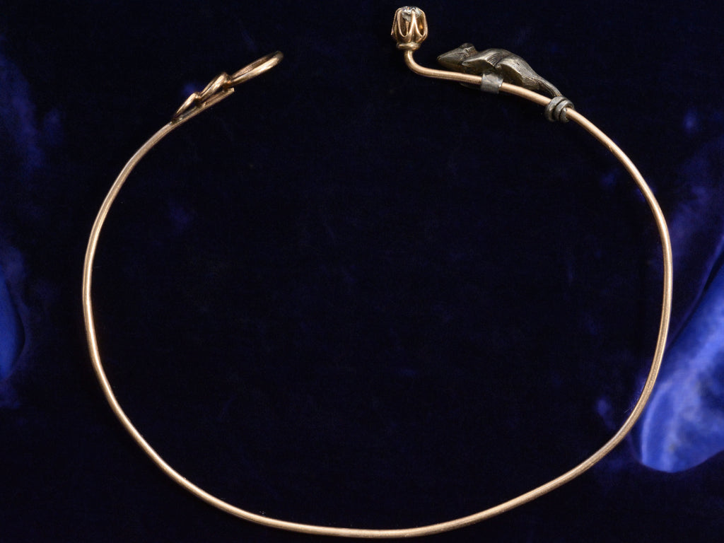 Side profile view showing bracelet open of c1890 Diamond Mouse Bracelet on dark blue background