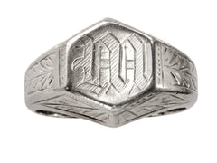 thumbnail of Front view of white gold Art Deco signet ring with a hexagonal top carved with a gothic script letter "M" and carved decorations on the sides, shown on white background.