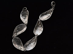 thumbnail of Reverse side of bracelet with mussel shell links, on black background. Inscribed "Sterling"