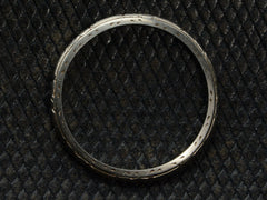 thumbnail of Side profile of c1930 Patterned Narrow 18K White Gold Wedding Band, on dark textured background.