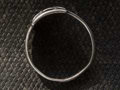 thumbnail of Side profile view of c1930 Navajo silver signet ring, shown on dark textured background.
