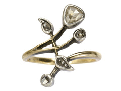 thumbnail of An antique Art Nouveau gold and silver ring with rose cut diamonds in a floral design. Shown on white background.
