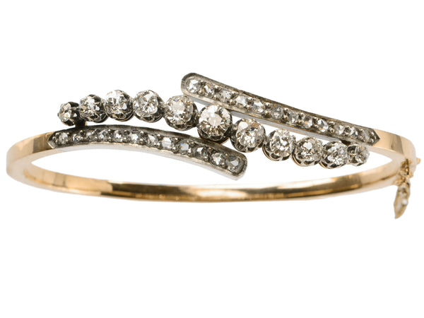 A platinum topped yellow gold Art Nouveau bracelet with rows of old European cut and rose cut diamonds, shown on white background.