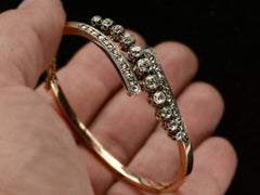 thumbnail of Hand holding a platinum topped yellow gold Art Nouveau bracelet with rows of old European cut and rose cut diamonds