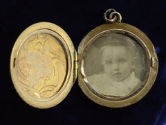 thumbnail of c1920 Gilt Art Nouveau Locket shown open with old photo of a child on the right side.  On dark background.