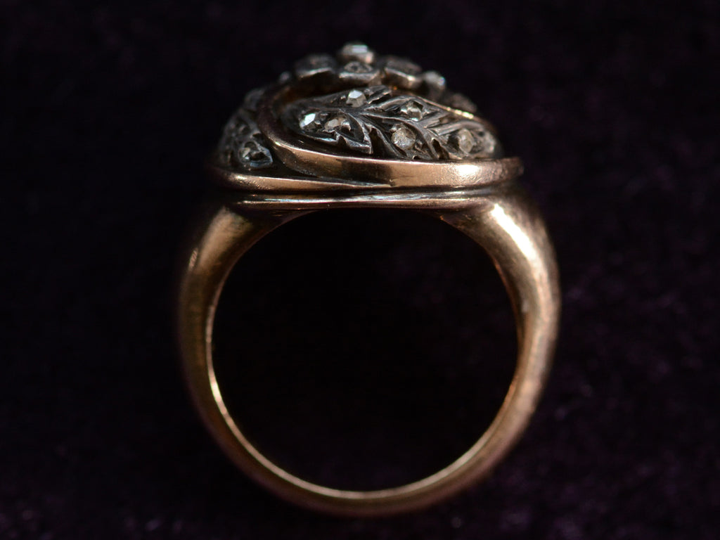 Side profile view of c1890 Art Nouveau Ring with Circular Top of Spiraling Rose Cut Diamond Silver Vines in a Gold Frame (shown on dark background)
