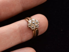 thumbnail of Front view of antique rosy-yellow gold ring with cluster of old mine cut diamonds, on finger