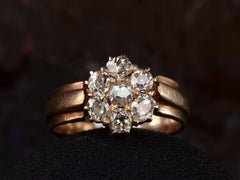 thumbnail of Front view of antique rosy-yellow gold ring with cluster of old mine cut diamonds, on black background.