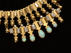 thumbnail of Detail view of c1930 Victorian-style 18K rosy-yellow gold collar with a small front bib of opals and diamonds, shown on black background.