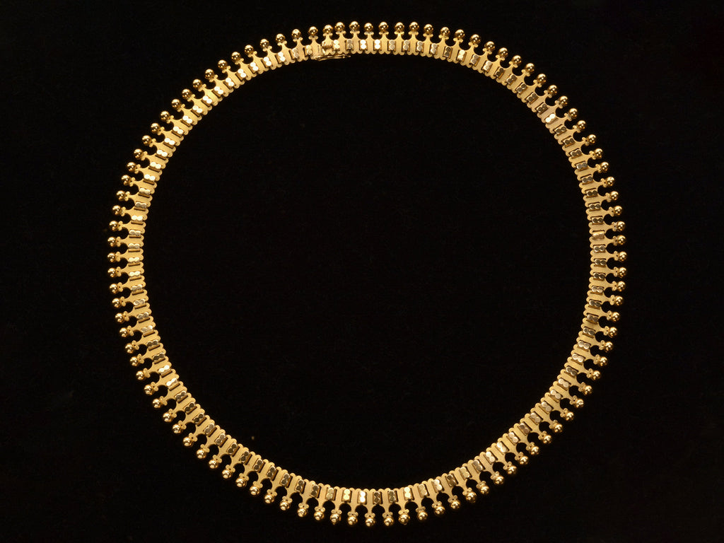 A c1930 Victorian-style 18K rosy-yellow gold collar shown without opal bib on black background.
