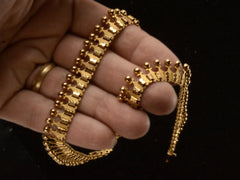 thumbnail of Detail of a c1930 Victorian-style 18K rosy-yellow gold collar necklace shown held in hand