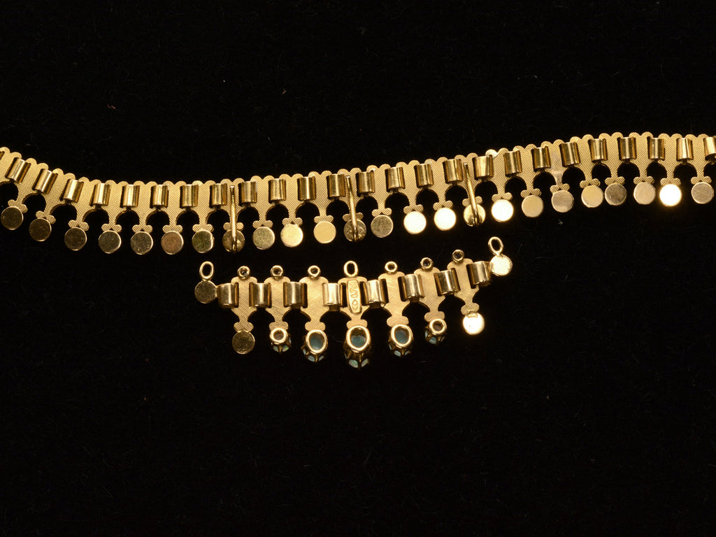 Reverse side detail view of c1930 Victorian-style 18K rosy-yellow gold collar with a small front bib of opals and diamonds, shown on black background. "750" stamp visible