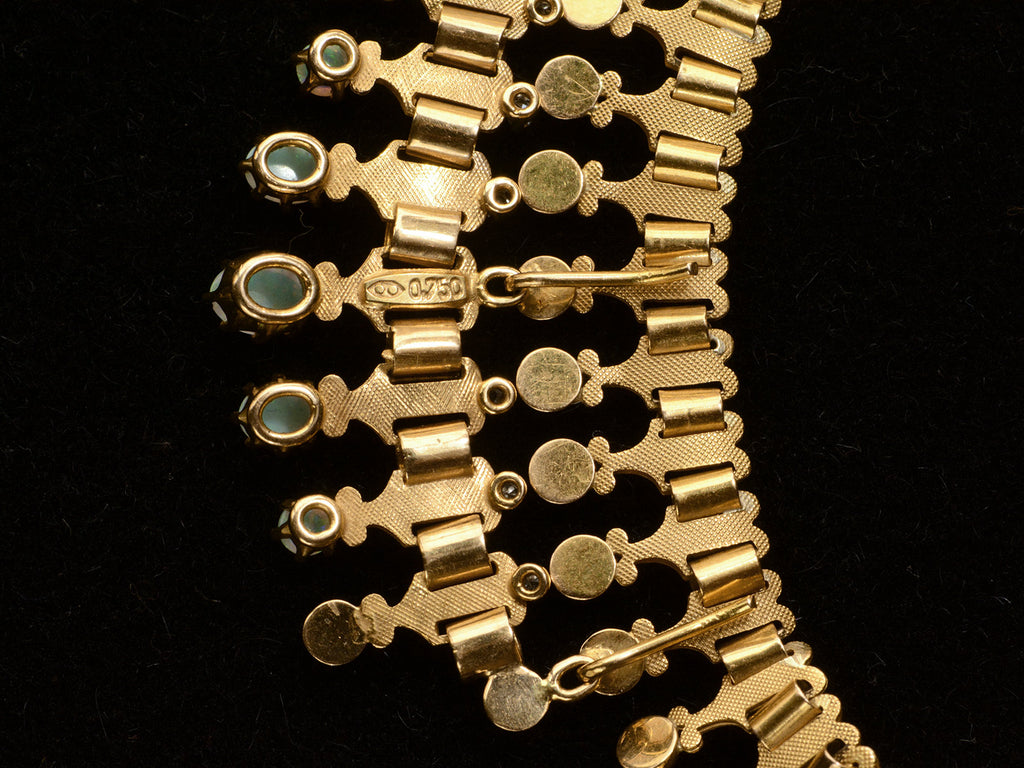 Detail reverse view of a c1930 Victorian-style 18K rosy-yellow gold collar with a small front bib of opals and diamonds, shown on black background. "0.750" stamp visible