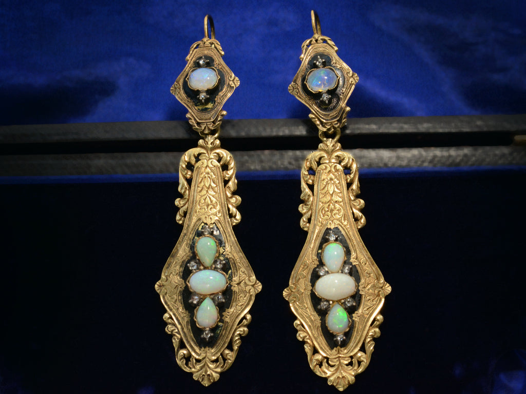 Front view of c1860 Opal & Black Enamel Earrings (shown on dark blue background)