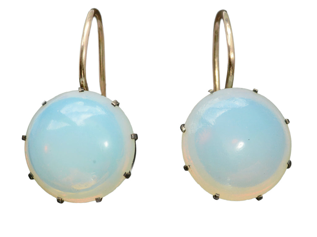 A vintage pair of round opaline glass earrings with blackened silver settings and 14K yellow gold ear wires. Shown on white background.