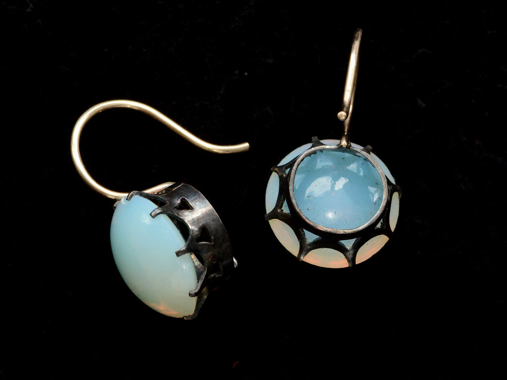 Reverse side views of vintage pair of round opaline glass earrings with blackened silver settings and 14K yellow gold ear wires. Shown on black background.
