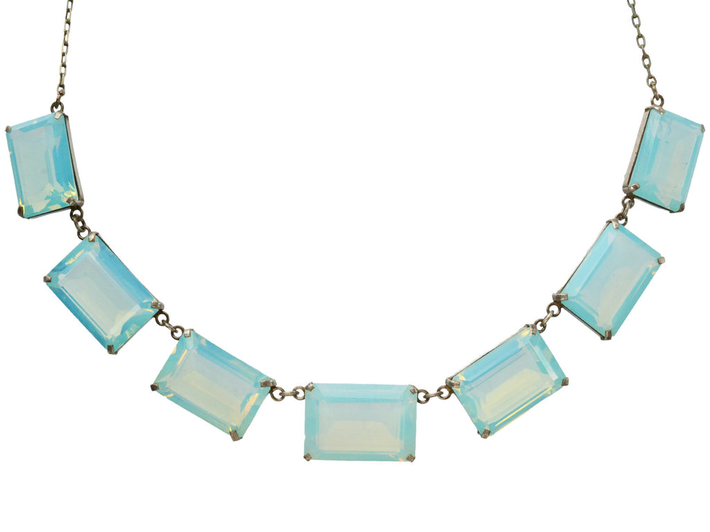 A vintage c1950 silver necklace with a bib of rectangular opalescent glass stones, shown on white background.