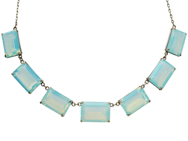 A vintage c1950 silver necklace with a bib of rectangular opalescent glass stones, shown on white background.