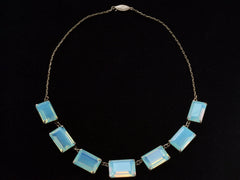 thumbnail of Full view of vintage c1950 silver necklace with a bib of rectangular opalescent glass stones, shown on black background.