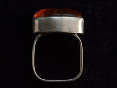 thumbnail of Side profile view of c1980 Oval Amber Ring in Sterling Silver (on dark background)