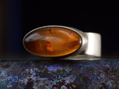 thumbnail of Right angled view of c1980 Oval Amber Ring in Sterling Silver (on dark background)