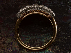 thumbnail of Side profile view of antique c1900 ring with an oval cluster of round old European cut diamonds set in platinum-topped 14K yellow gold, shown on dark background.