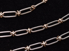 thumbnail of c1900 Long Silver and Gold Filled Chain (detail of links on black background)