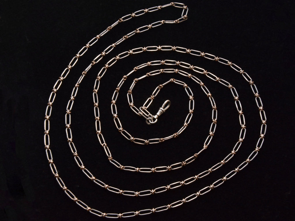 c1900 Long Silver and Gold Filled Chain (shown on black background)