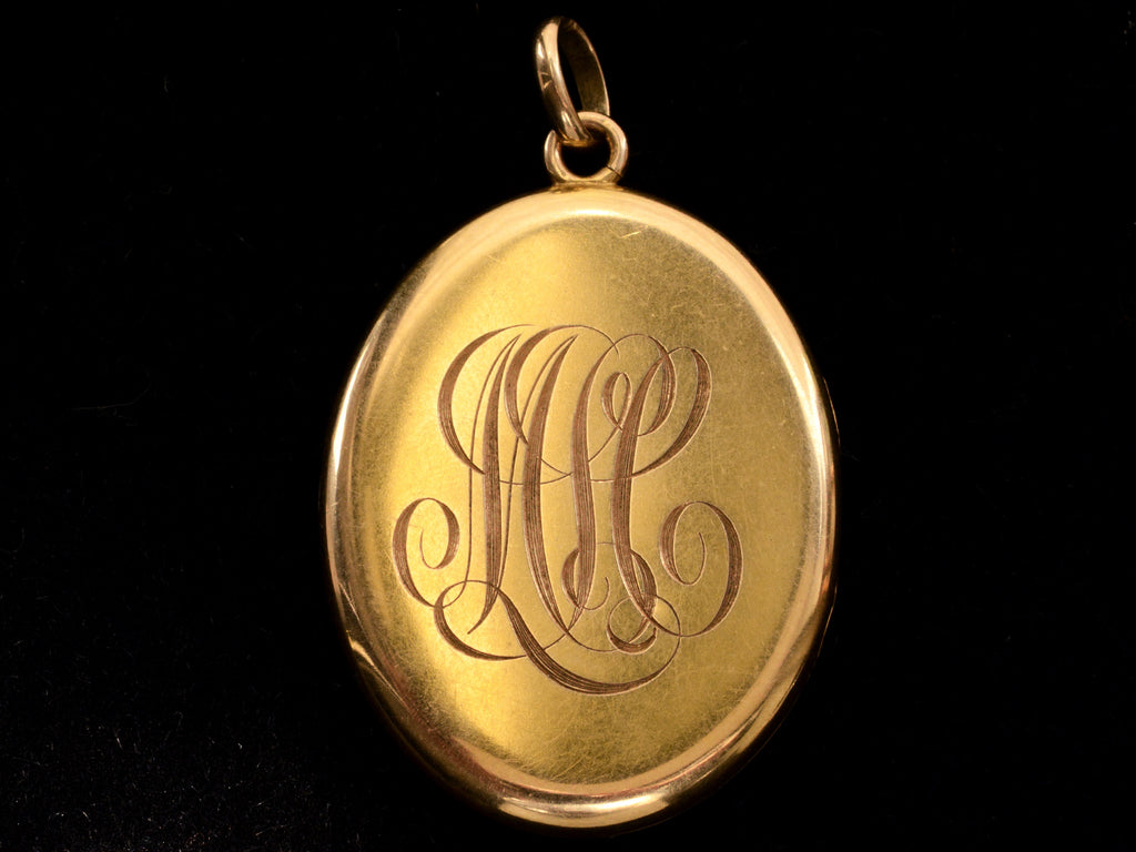 c1900 Large Oval Diamond Locket (backside showing MLC monogram on black background)