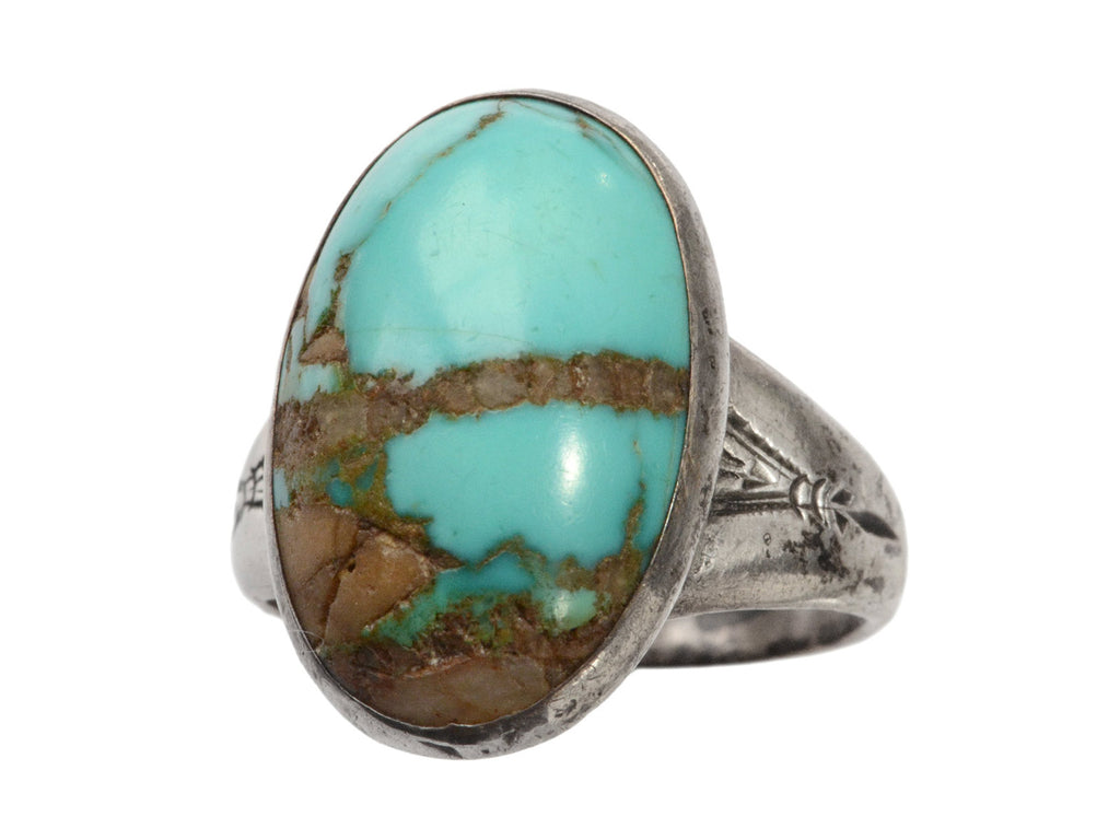 Angled front view of c1950 Navajo Turquoise Ring in silver on white background.