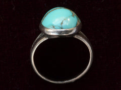 thumbnail of Side profile view of c1950 Navajo Turquoise Ring in silver on black background.