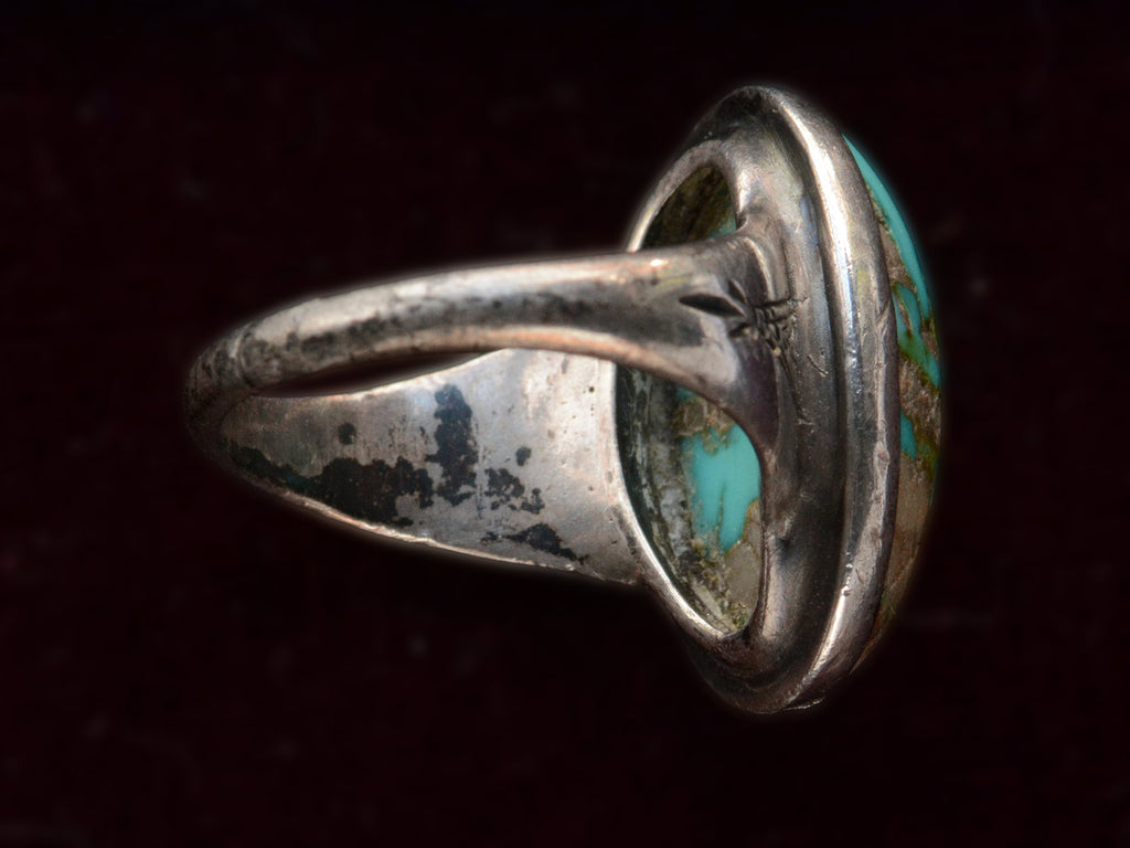 Inside view of c1950 Navajo Turquoise Ring in silver on black background.