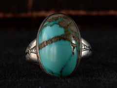 thumbnail of Front view of c1950 Navajo Turquoise Ring in silver on black background.