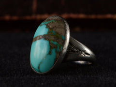 thumbnail of Right side view of c1950 Navajo Turquoise Ring in silver on black background.