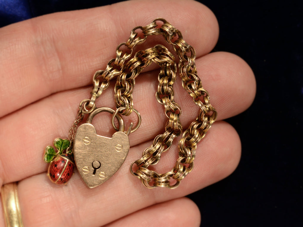 1904 Gold Padlock Bracelet with Ladybug and Clover Charms (shown on hand for scale)