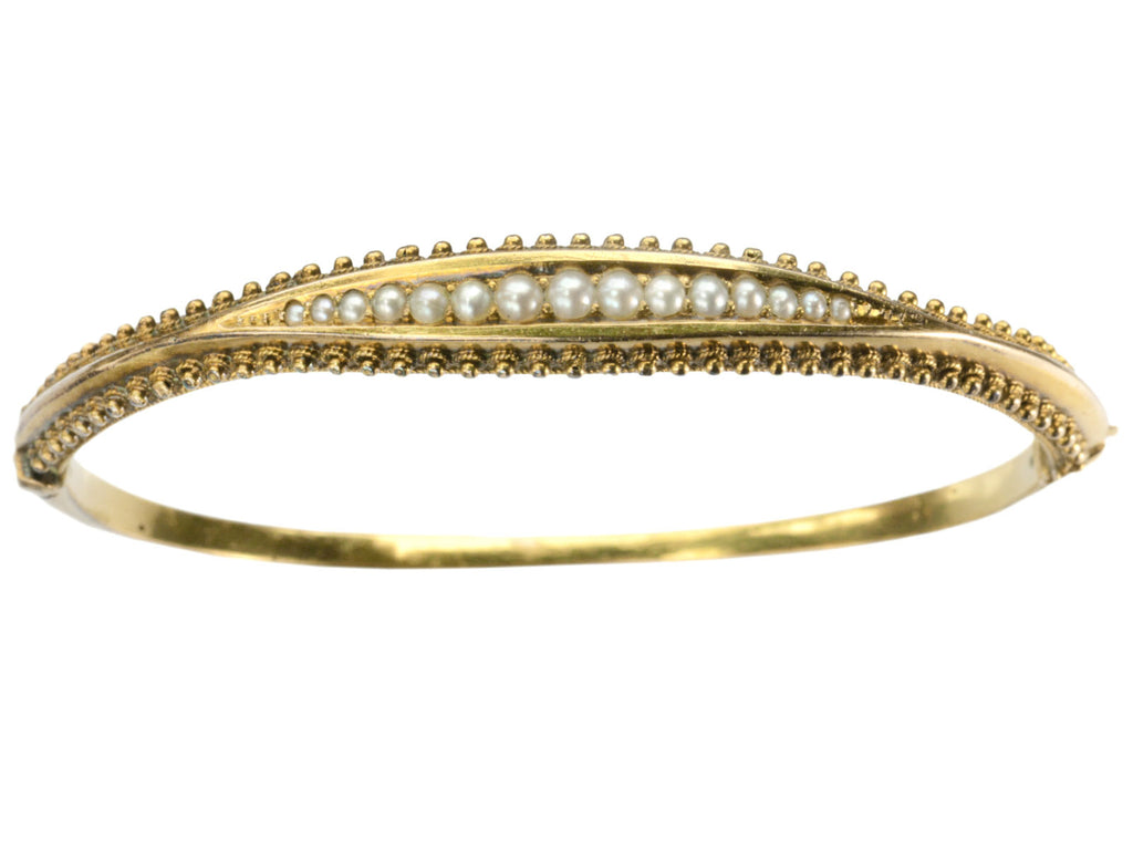 A narrow gold Victorian Pearl Bracelet with intricate Etruscan Revival granulation detailing, shown on white background.