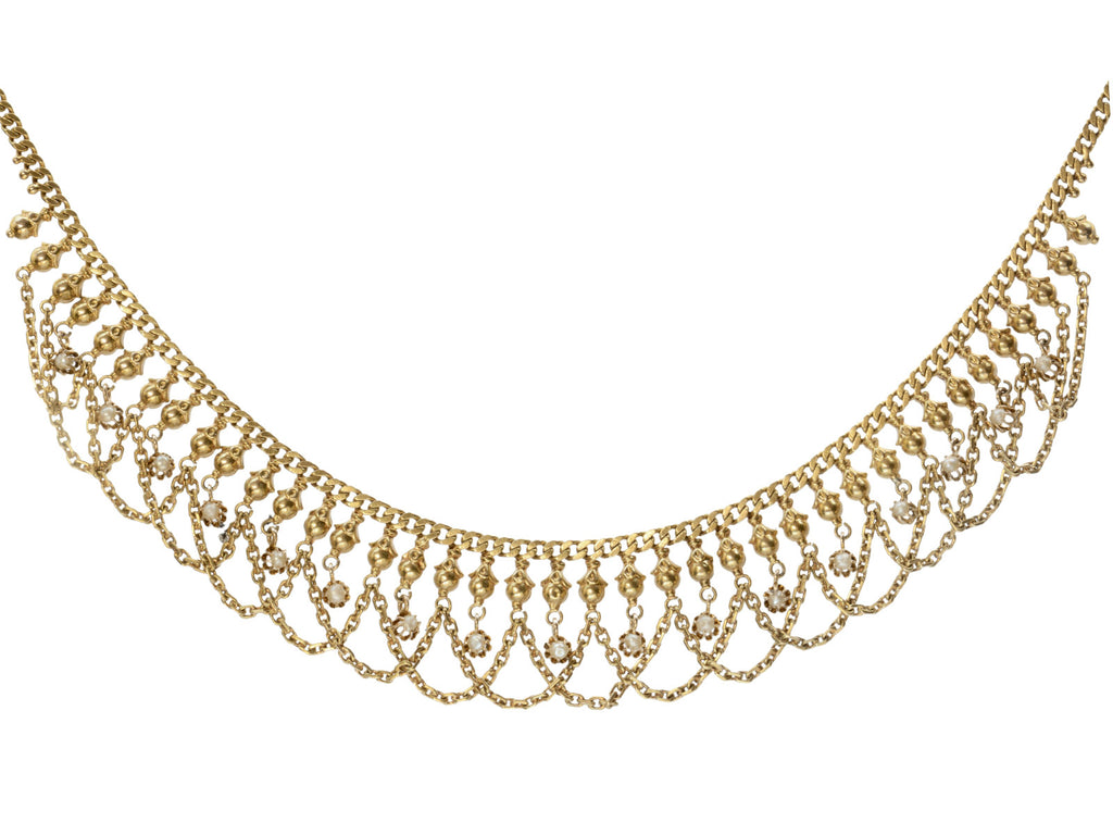Detail view of a c1900 Edwardian chain collar with tiny seed pearl pendants and chain swags. Built in 14K yellow gold. Shown on white background.