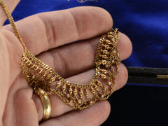 thumbnail of Detail view of a yellow gold c1900 Edwardian chain collar with tiny seed pearl pendants and chain swags shown on hand.