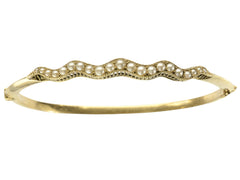 thumbnail of A thin gold c1900 Art Nouveau bracelet with a wavy line of pearls. Shown on white  background.
