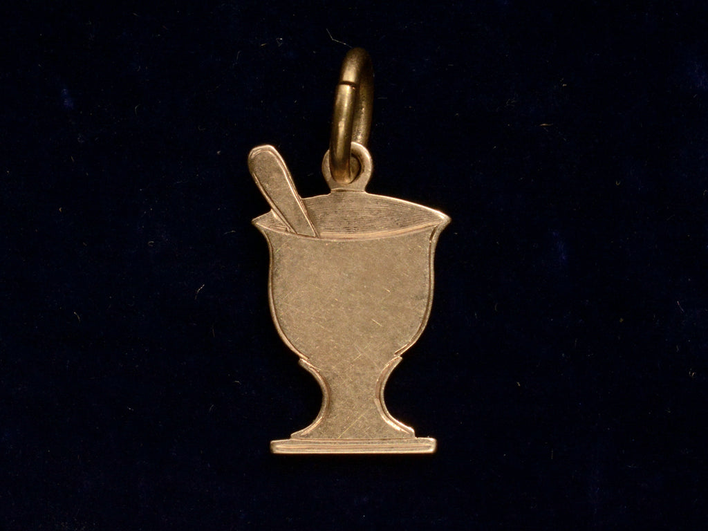 c1890 Gold Pharmacy Mortar and Pestle Charm, reverse side shown on black background