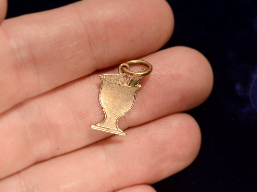 c1890 Gold Pharmacy Mortar and Pestle Charm, shown on hand for scale