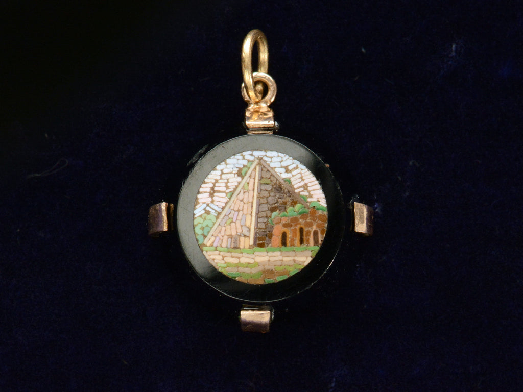 c1870 Black and Gold Round Pendant with a Micromosaic Image of a Pyramid (shown on dark purple background)