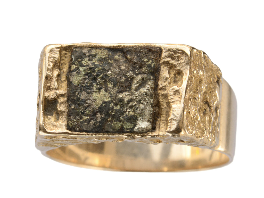 Angled view of vintage pyrite signet ring in textured 14K yellow gold mounting, made by Lapponia. Shown on white background.