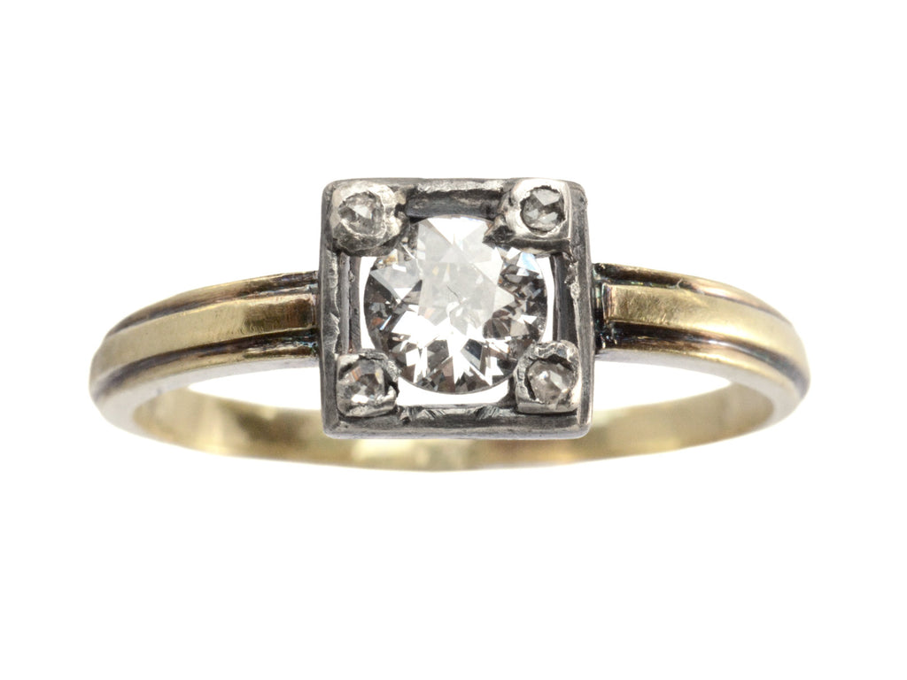 Antique silver-topped yellow gold ring with round diamond set on four prongs topped with tiny rose cut diamonds, shown on white background.