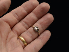 thumbnail of Antique silver-topped yellow gold ring with round diamond set on four prongs topped with tiny rose cut diamonds, shown on hand.