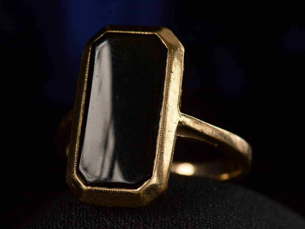 Right angle view of c1920 Rectangular Onyx and Yellow Gold Signet Ring (shown on dark background)